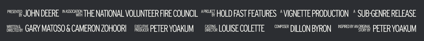A list of production credits for a film, displayed in white sans-serif text against a dark gray background, includes John Deere as the presenter and the National Volunteer Fire Council as an associate, alongside the names of the writers, directors, executive producer, casting director, composer, and original story writer.